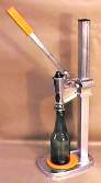 This is a fully adjustable bench capper that fits all size beer bottles. A magnet inside the bell holds the crown seal in place while positioning the bottle for sealing.

Hand cappers and lever style cappers can smash bottles or rip the rim off the top of your bottle. The steady pressure applied down the length of the bottle while the crown seal is applied by the Super Automatica ensures a strong seal and reduced breakage when bottling your beer.

This is a must for the serious home brewer.

*** The standard bell can be replaced with one that takes the tirage style champagne bottle crown seal